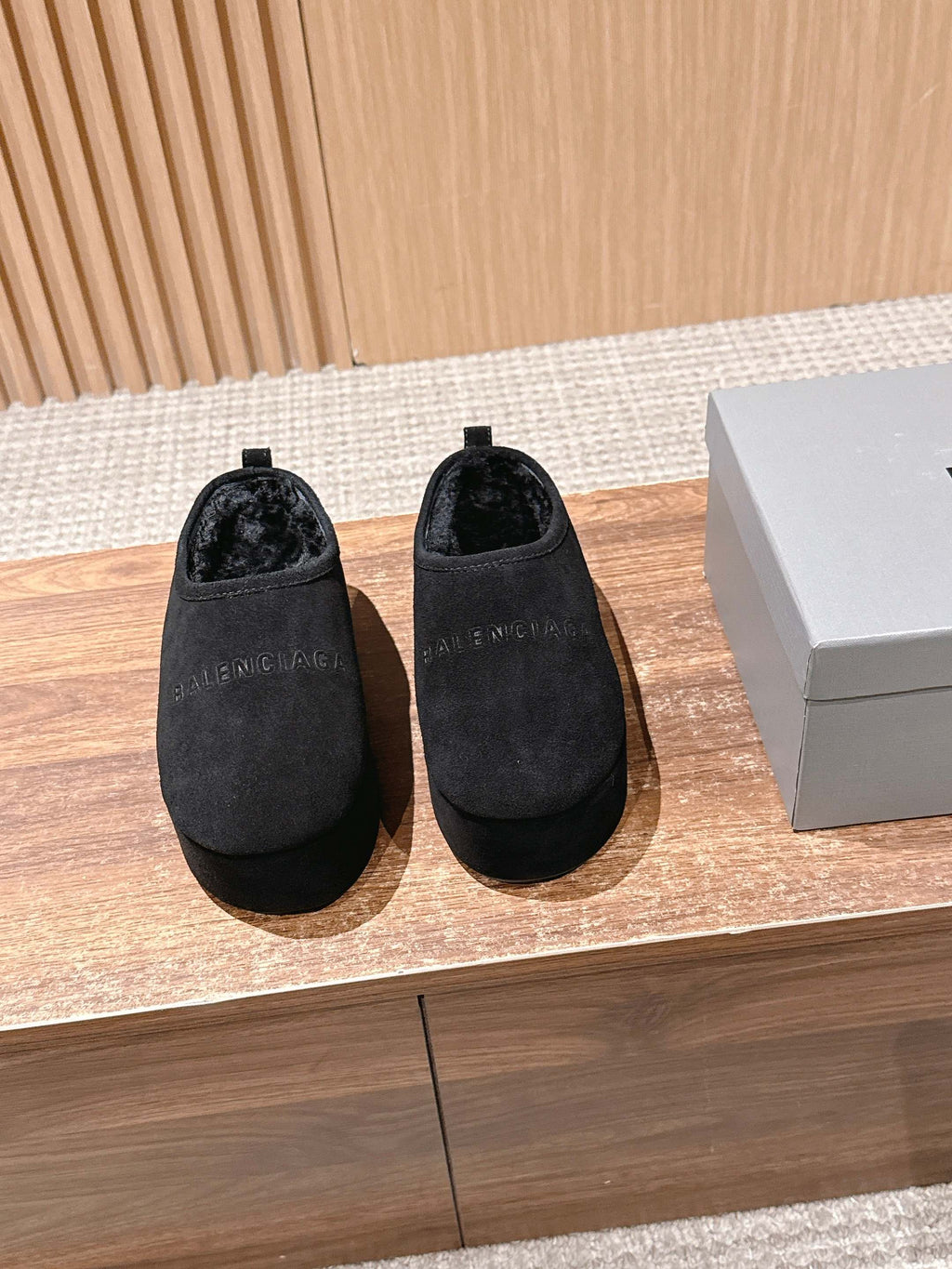 Black suede slip-on mules with rounded toe and short pull tab at back