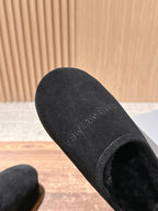 Black Balenciaga slip-on sandal, underside view with textured footbed and logo