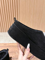 Black suede slip-on mule with side stitching and pull-on tab detail
