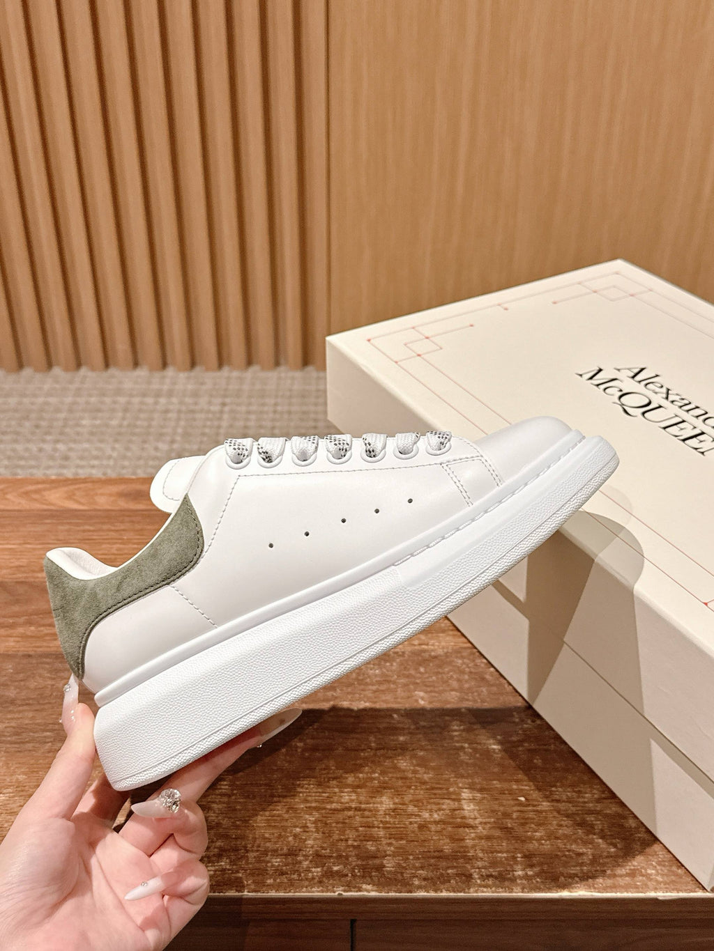 Alexander McQueen white leather sneaker with olive heel panel and lace-up closure
