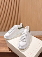 Alexander McQueen white leather lace-up sneakers with olive heel trim