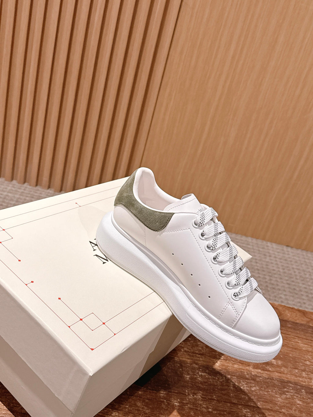 White lace-up sneaker with olive suede collar and textured cupsole sole