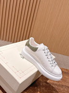 White lace-up sneaker with olive suede collar and textured cupsole sole
