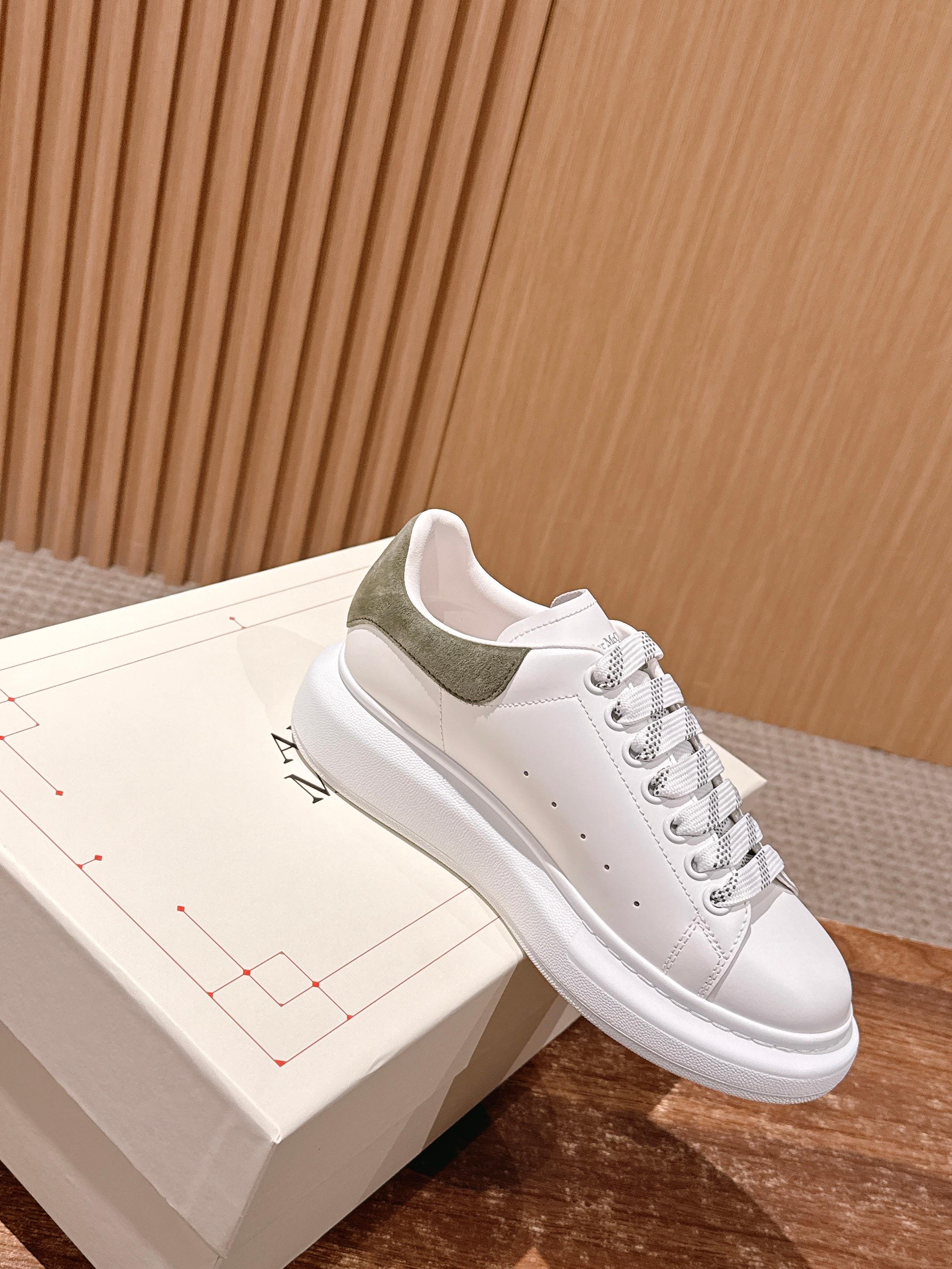 Alexander McQueen white lace-up sneaker with olive heel panel and perforated toe