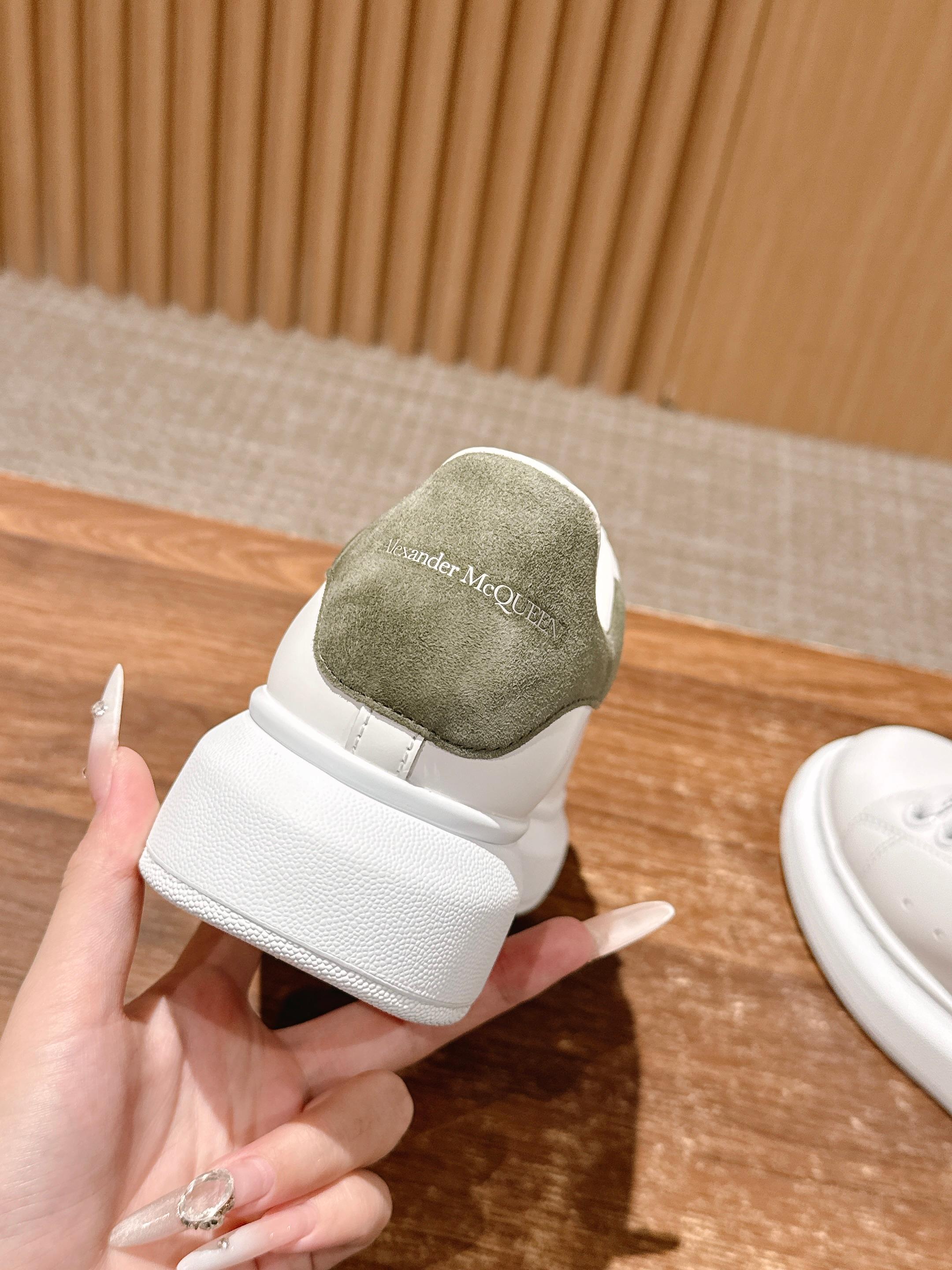 Alexander McQueen white sneaker heel with olive suede panel and cushioned collar