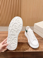 White sneaker outsole with textured tread and matching white upper