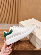 Alexander McQueen white leather sneakers with green heel and perforated toe
