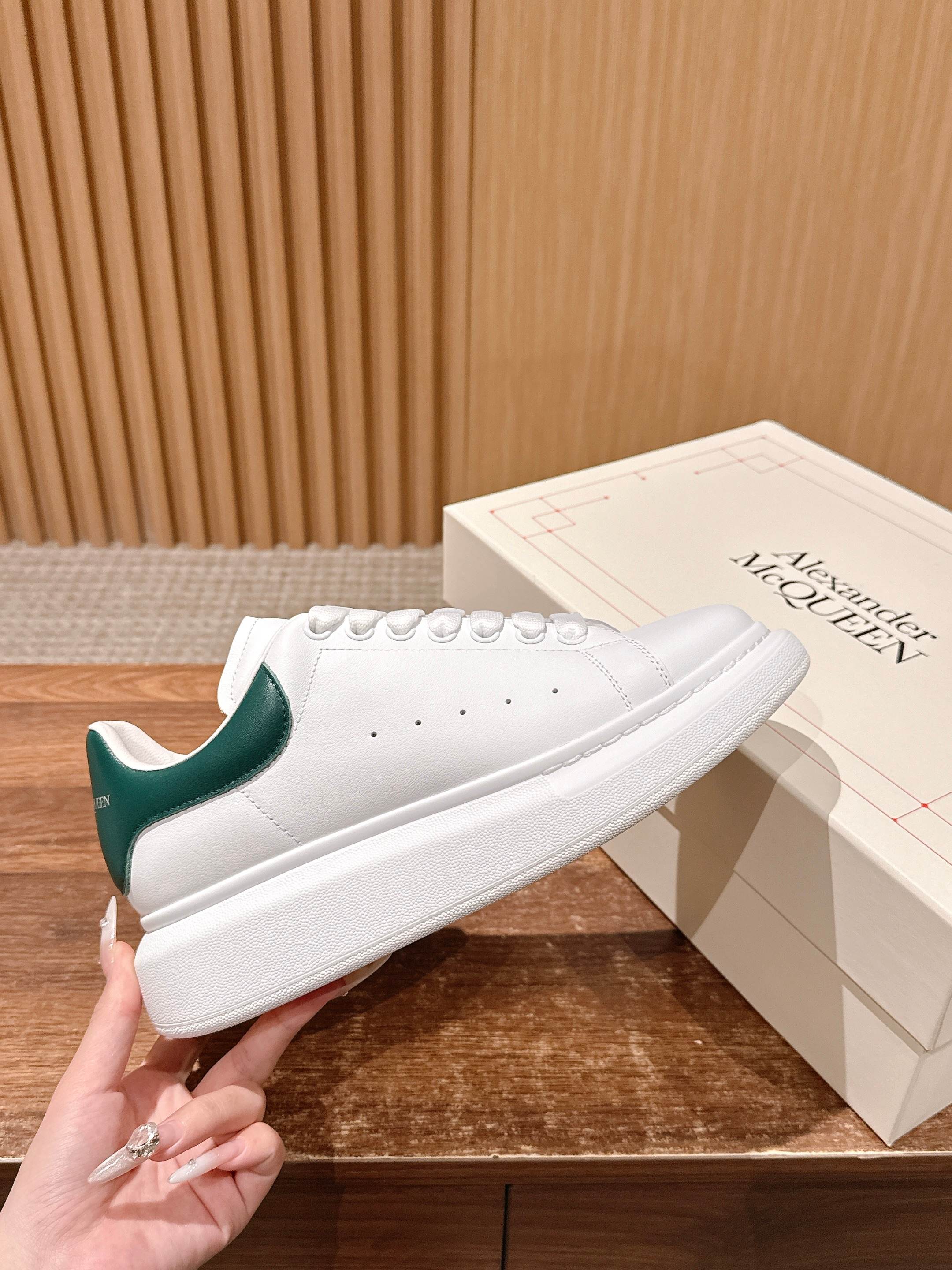 Alexander McQueen white leather sneakers with green heel and perforated toe
