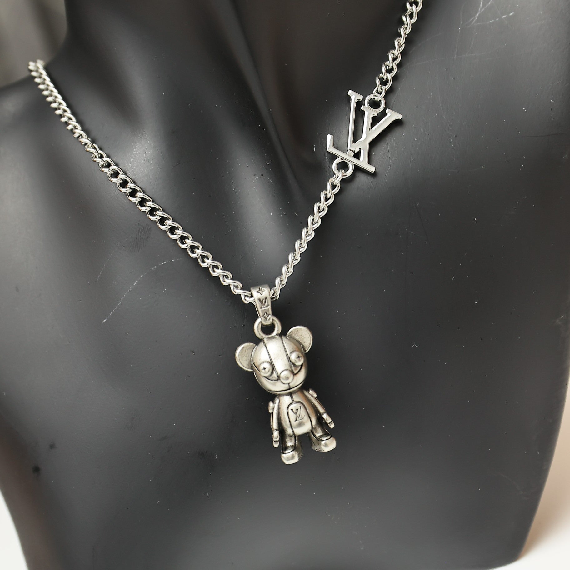 Silver chain necklace with LV logo charm and bear figurine pendant