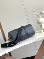 Louis Vuitton duffel bag side view in dark navy monogram canvas with crossbody strap