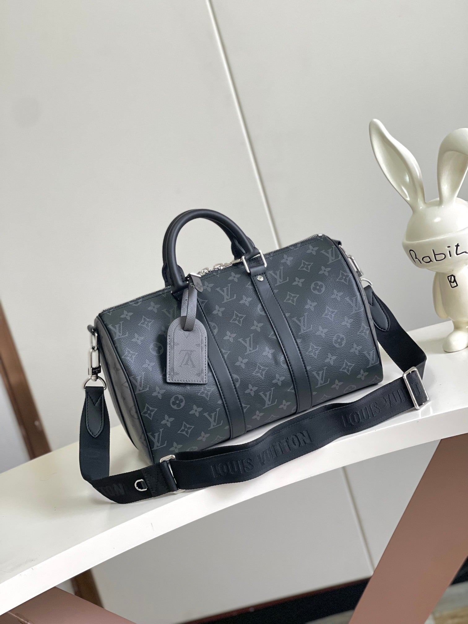Louis Vuitton duffel bag in dark navy monogram canvas with handles and shoulder strap