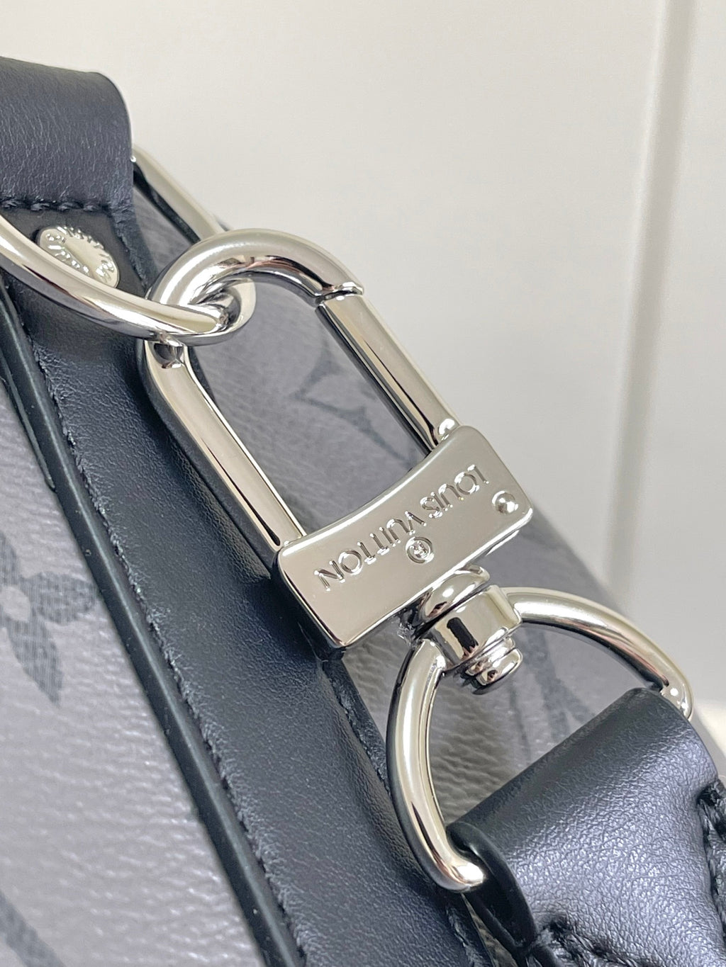 Louis Vuitton bag key holder and clasp on dark navy leather trim