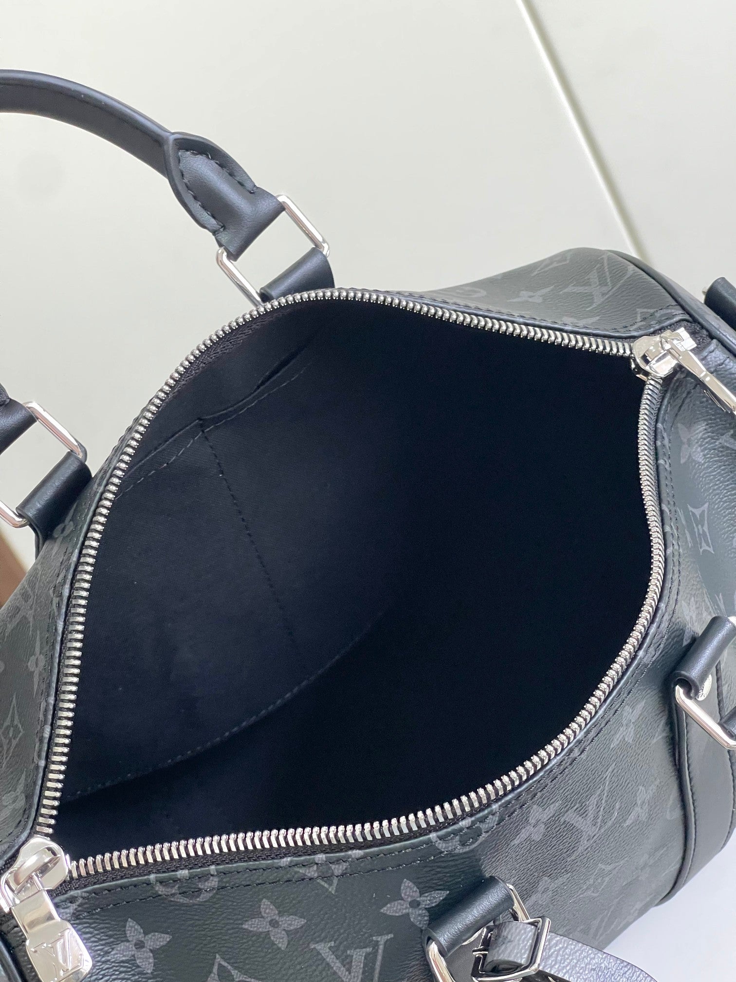 Louis Vuitton bag interior view through open zipper in dark navy monogram canvas