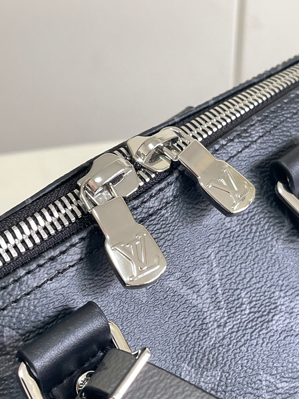 Louis Vuitton bag zipper pulls with silver hardware on dark navy leather