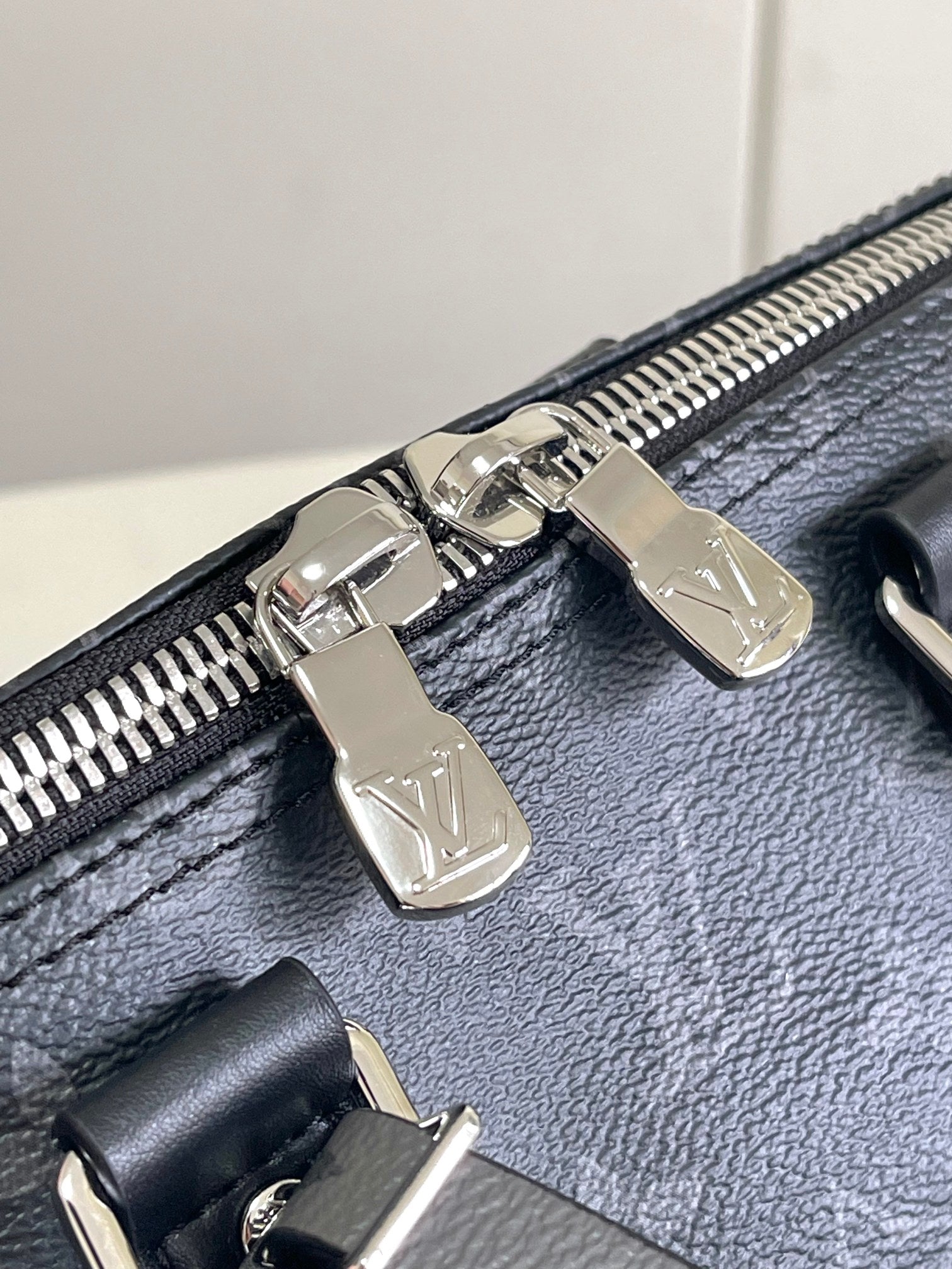 Louis Vuitton bag zipper pulls with silver hardware on dark navy leather