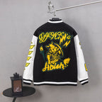 Black varsity jacket with large yellow graphic on back and striped ribbed cuffs