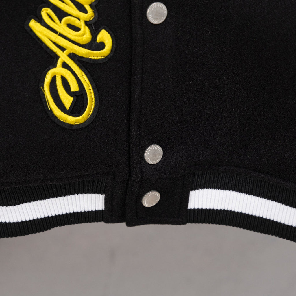 Black varsity jacket front with snap buttons and ribbed black-white hem