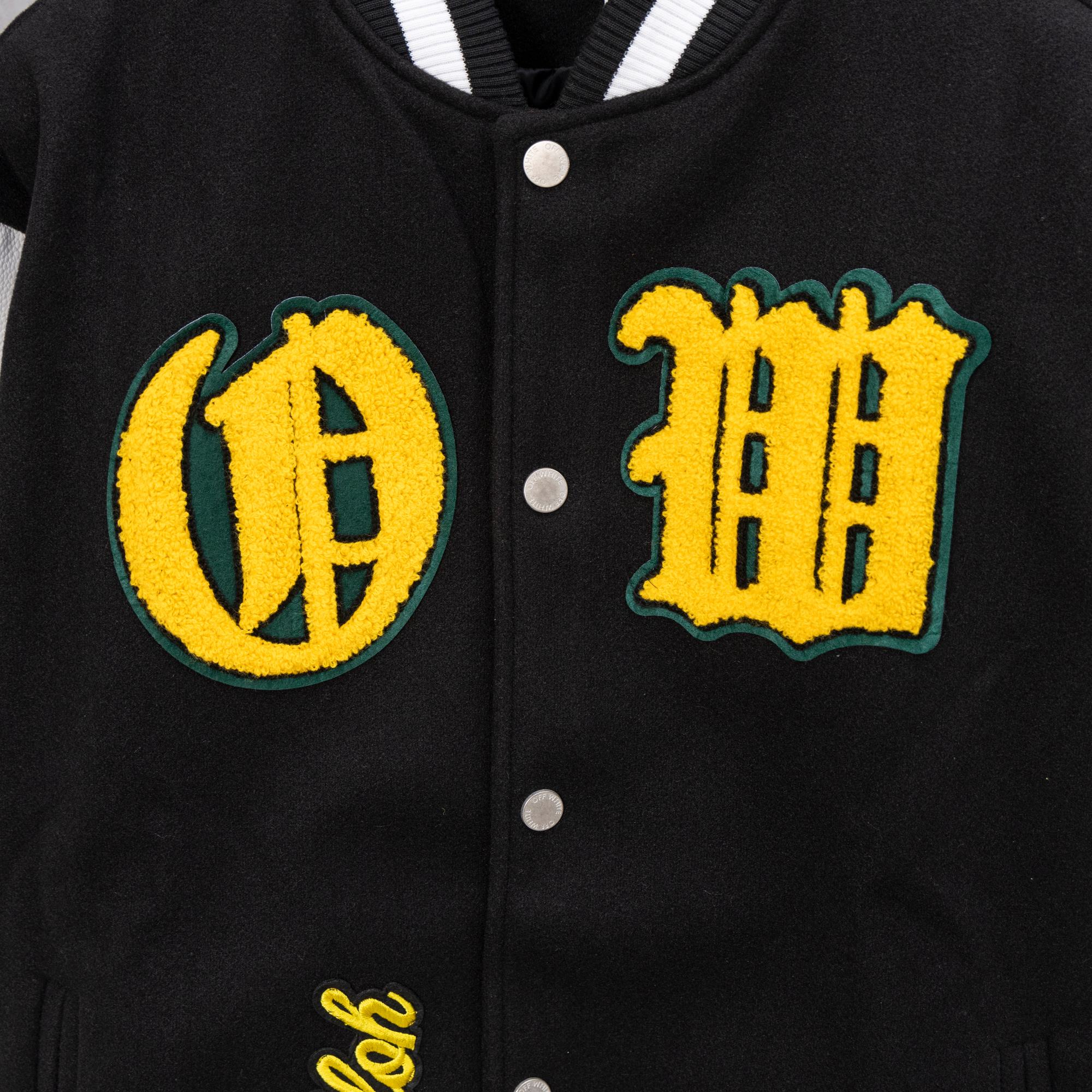 Black varsity jacket with yellow round C and HH embroidered patches