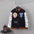 Black varsity jacket with orange trim, white sleeves, snap buttons, and front logo patches.