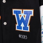 Black varsity jacket chest with large blue W graphic, small '2013' text, snap buttons.