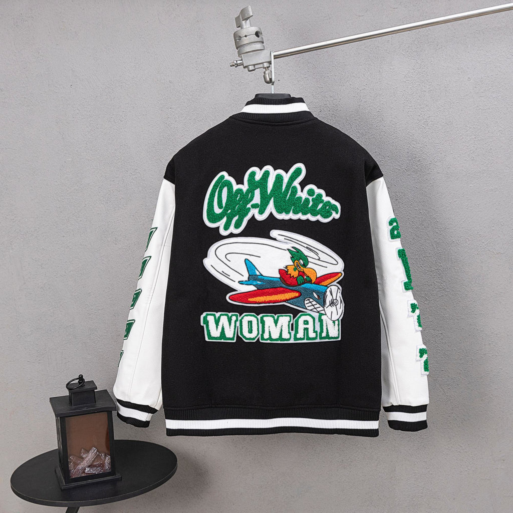 Black varsity jacket with green O-Woman back graphic and white striped cuffs