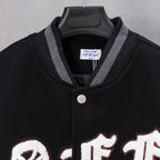Black varsity jacket collar with striped ribbing and snap-button placket.