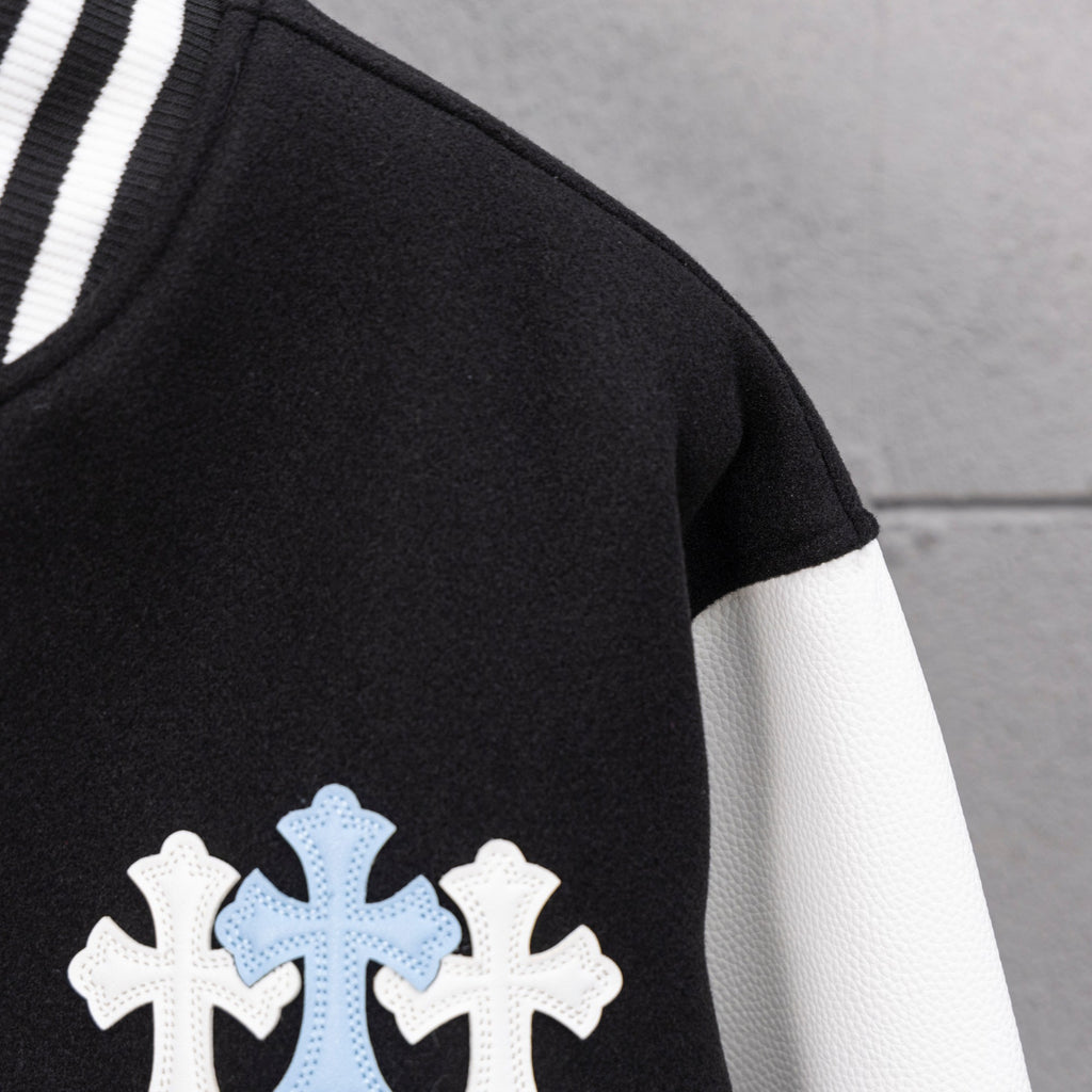 Black jacket with light blue cross applique on the front sleeve area