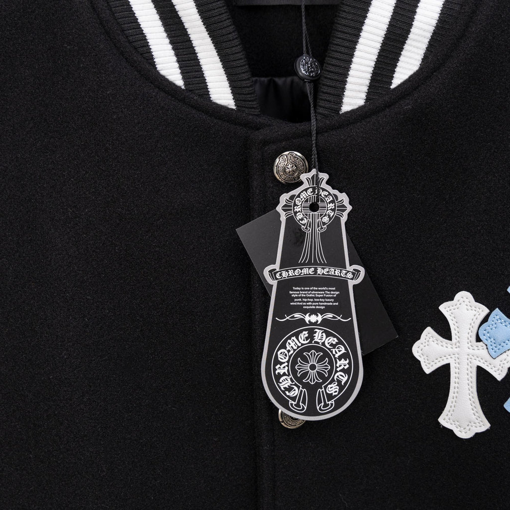 Black jacket with striped ribbed collar, metal button closure, hanging tag, cross applique