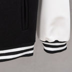Black jacket hem with striped ribbing and white contrast sleeve