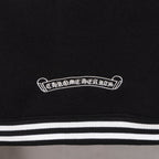 Black jacket chest patch above striped waistband-style trim