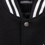 Black jacket neckline with striped ribbed trim and metal button closure