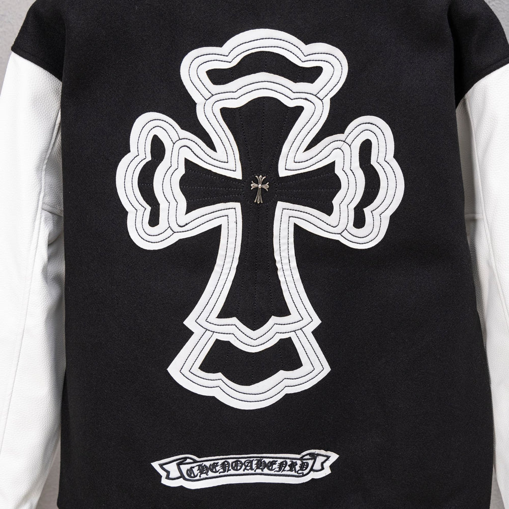Black varsity jacket with large white cross logo and striped hem band