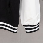 Black and white striped ribbed cuff and hem on varsity jacket sleeve
