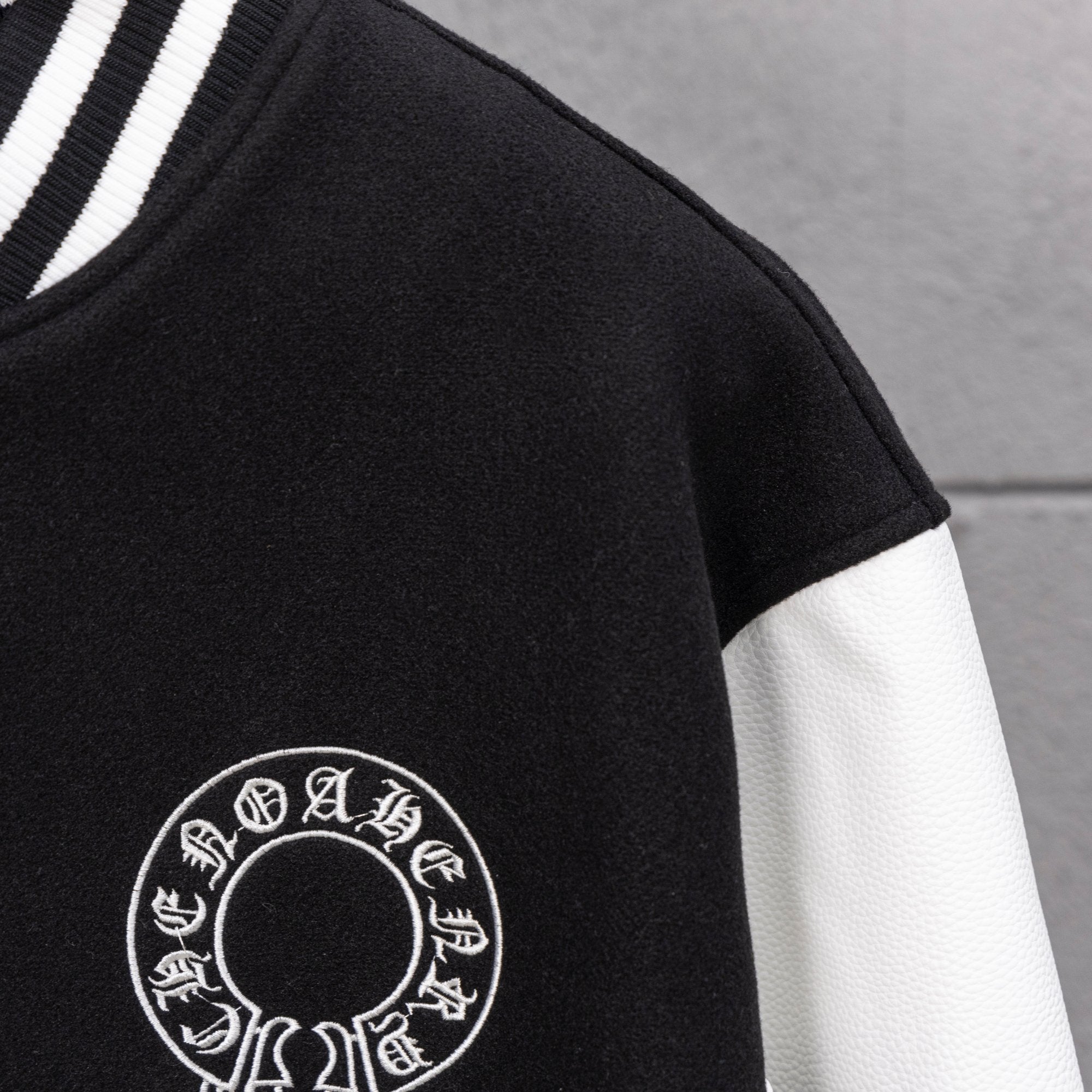 Black jacket sleeve with white circular emblem print