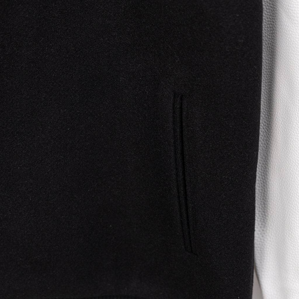 Black jacket with vertical seam detail and subtle knit texture