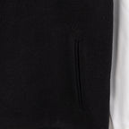 Black jacket with vertical seam detail and subtle knit texture