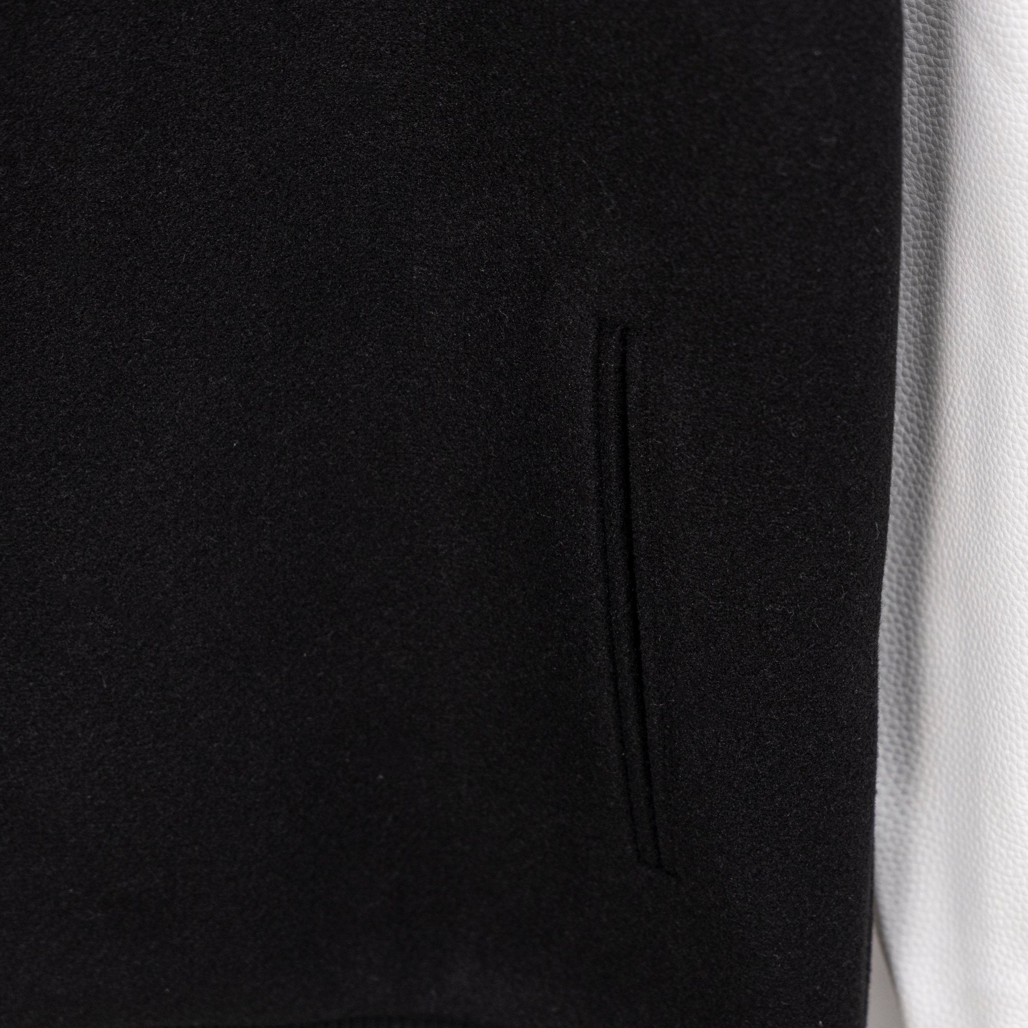 Black jacket with vertical seam detail and subtle knit texture