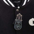 Black varsity collar with striped ribbing and snap button detail