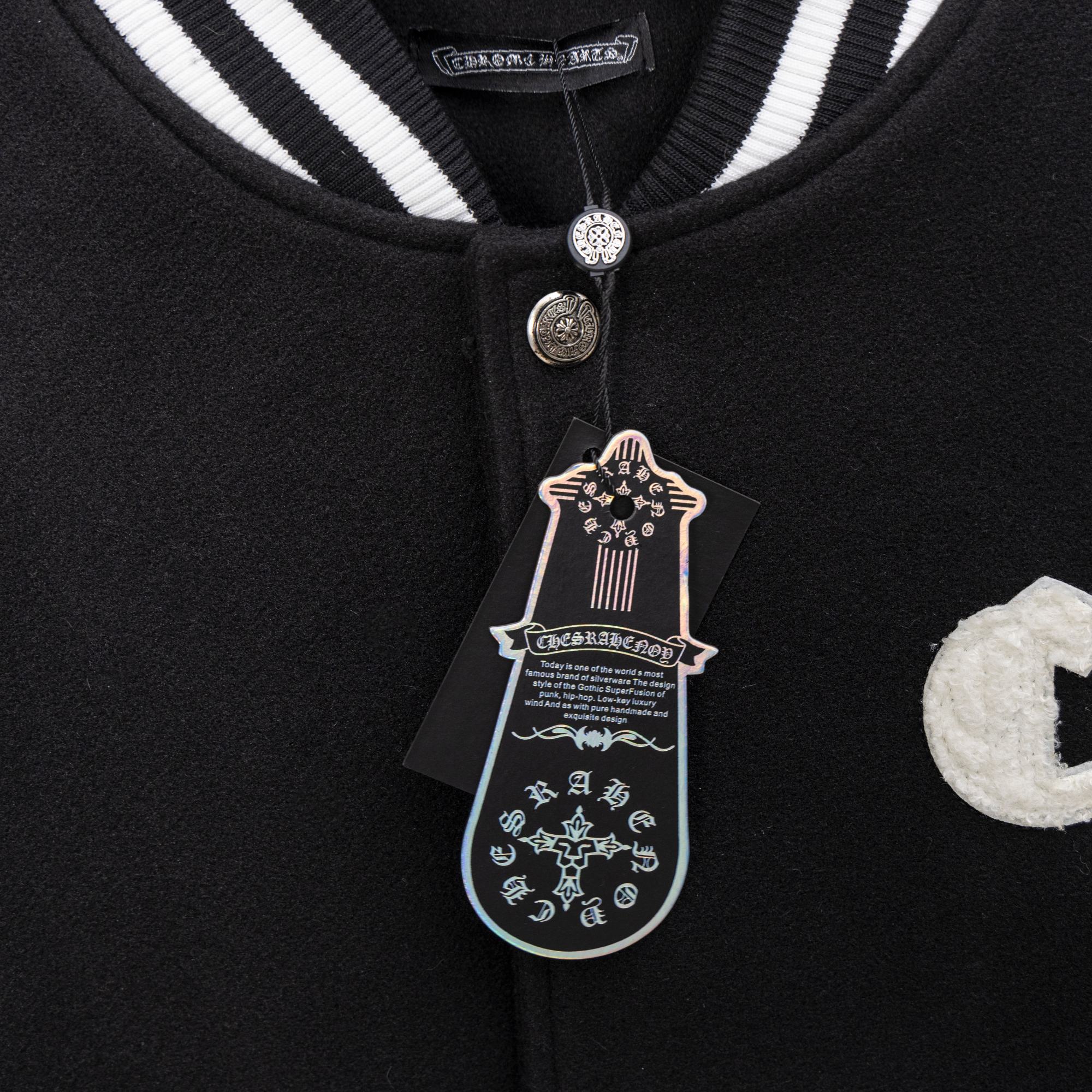 Black varsity collar with striped ribbing and snap button detail