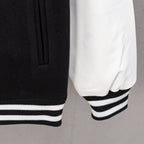 White sleeve with black panel and striped ribbed cuff on varsity jacket