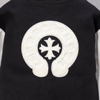 Black varsity jacket back with large white cross-in-curls emblem