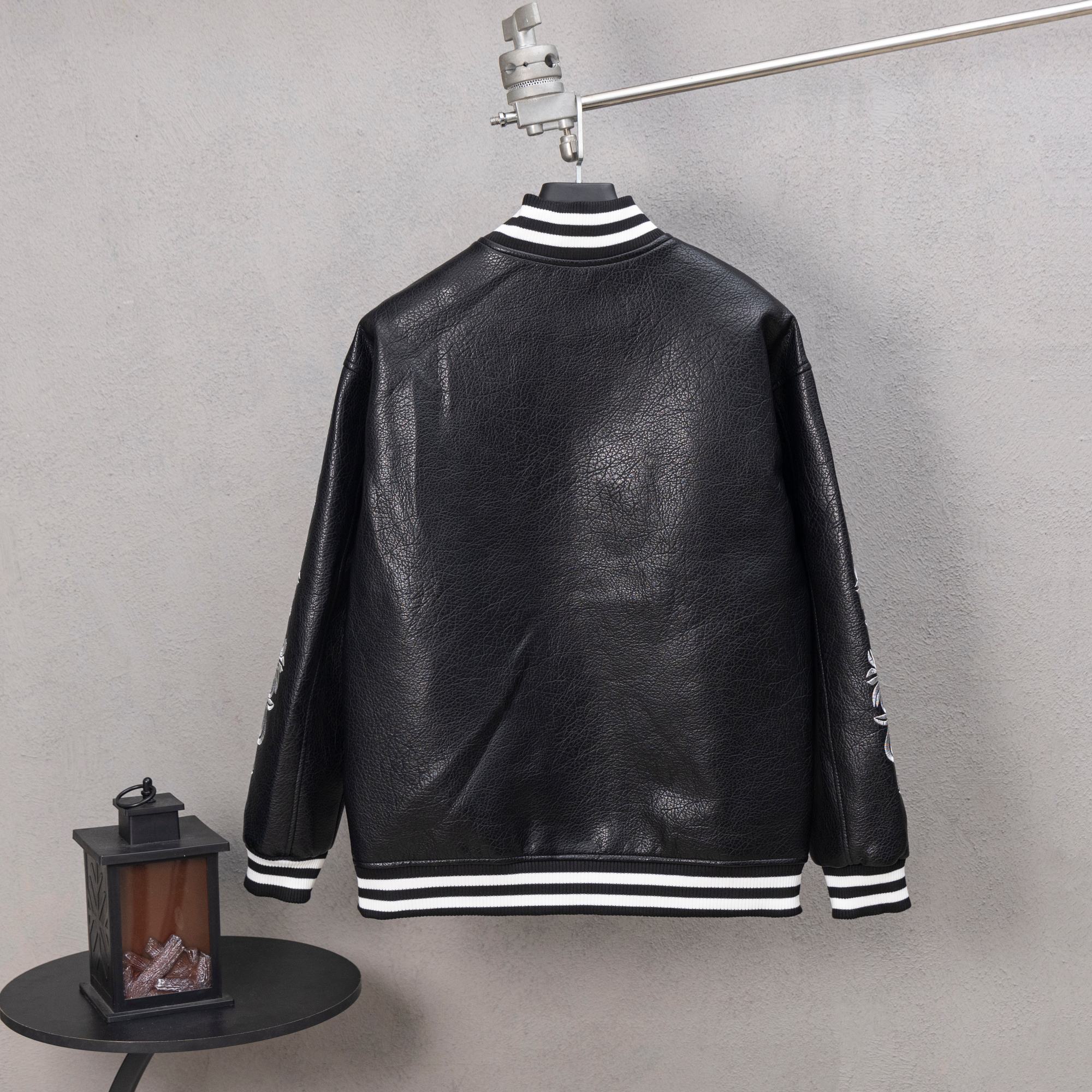Back view of black leather varsity jacket with white striped hem and ribbed cuffs
