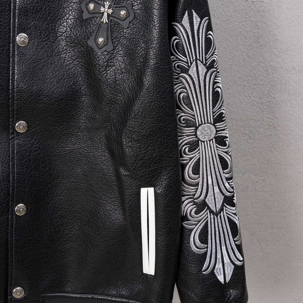 Black leather varsity jacket front with cross applique and ornate sleeve embroidery