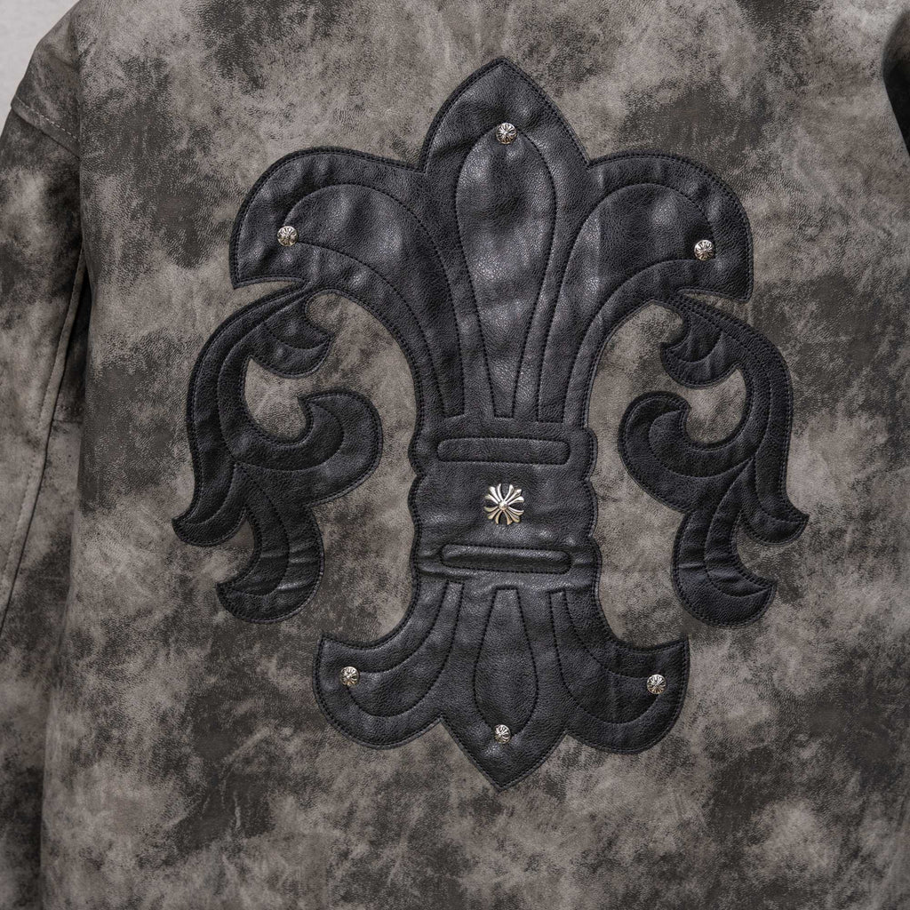 Varsity jacket front with large black fleur-de-lis patch, studded detailing and raised embroidery