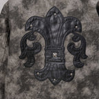 Varsity jacket front with large black fleur-de-lis patch, studded detailing and raised embroidery