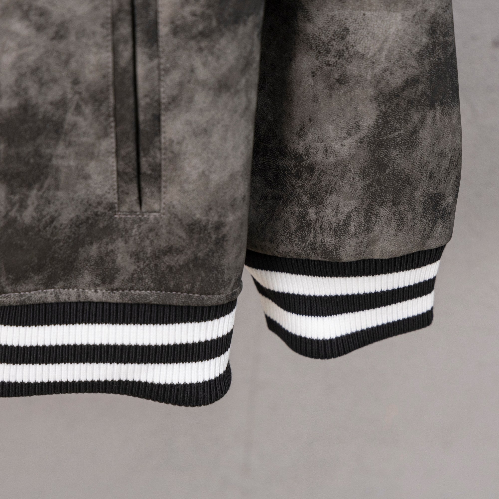 Long-sleeve varsity jacket sleeve cuff with ribbed black-and-white stripes