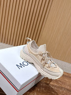 Moncler beige lace-up sneaker with raised sole on a white box.