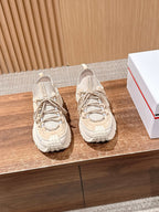 Moncler beige lace-up sneakers with chunky sole, shown as a pair.