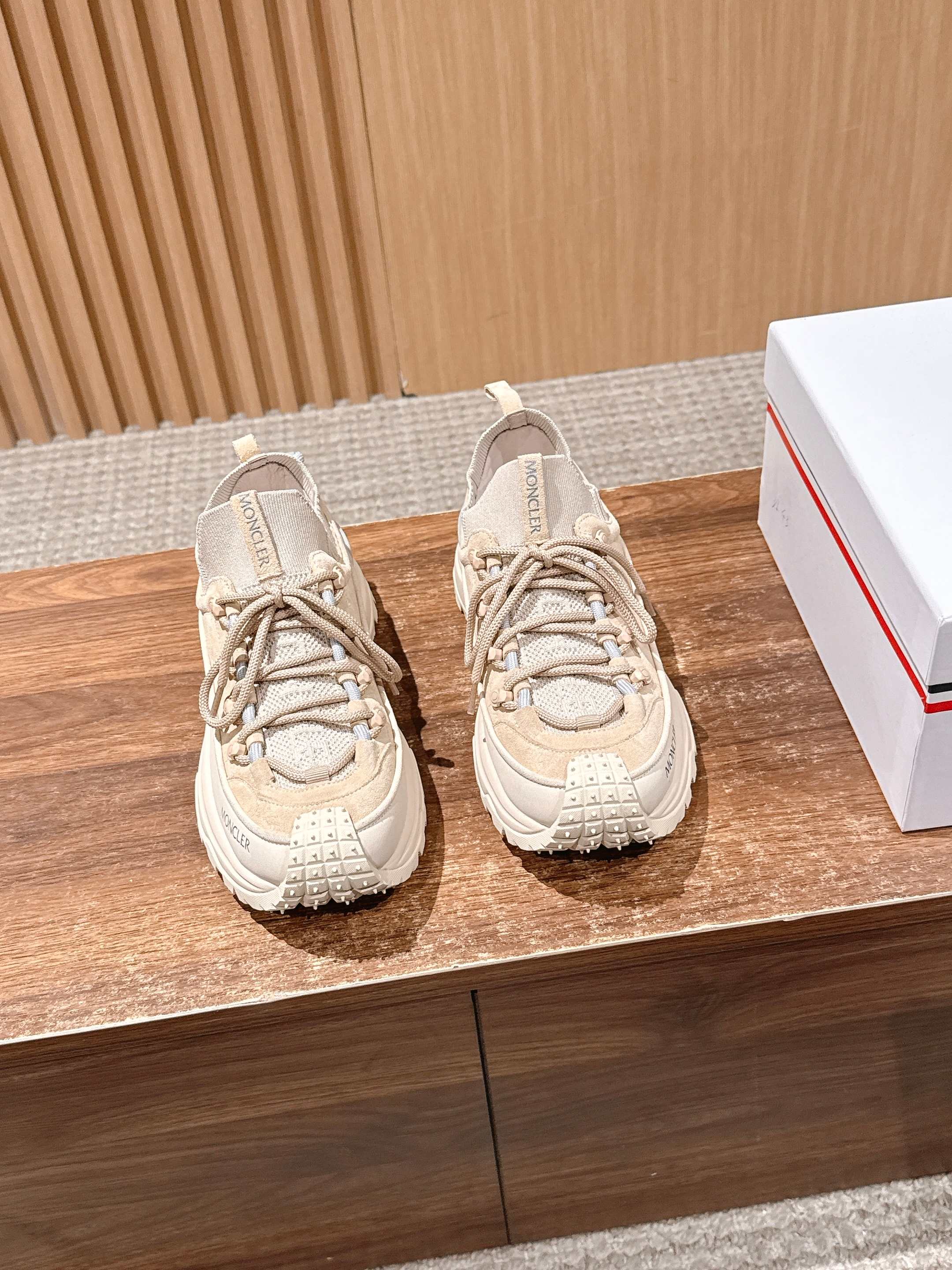 Moncler beige lace-up sneakers with chunky sole, shown as a pair.