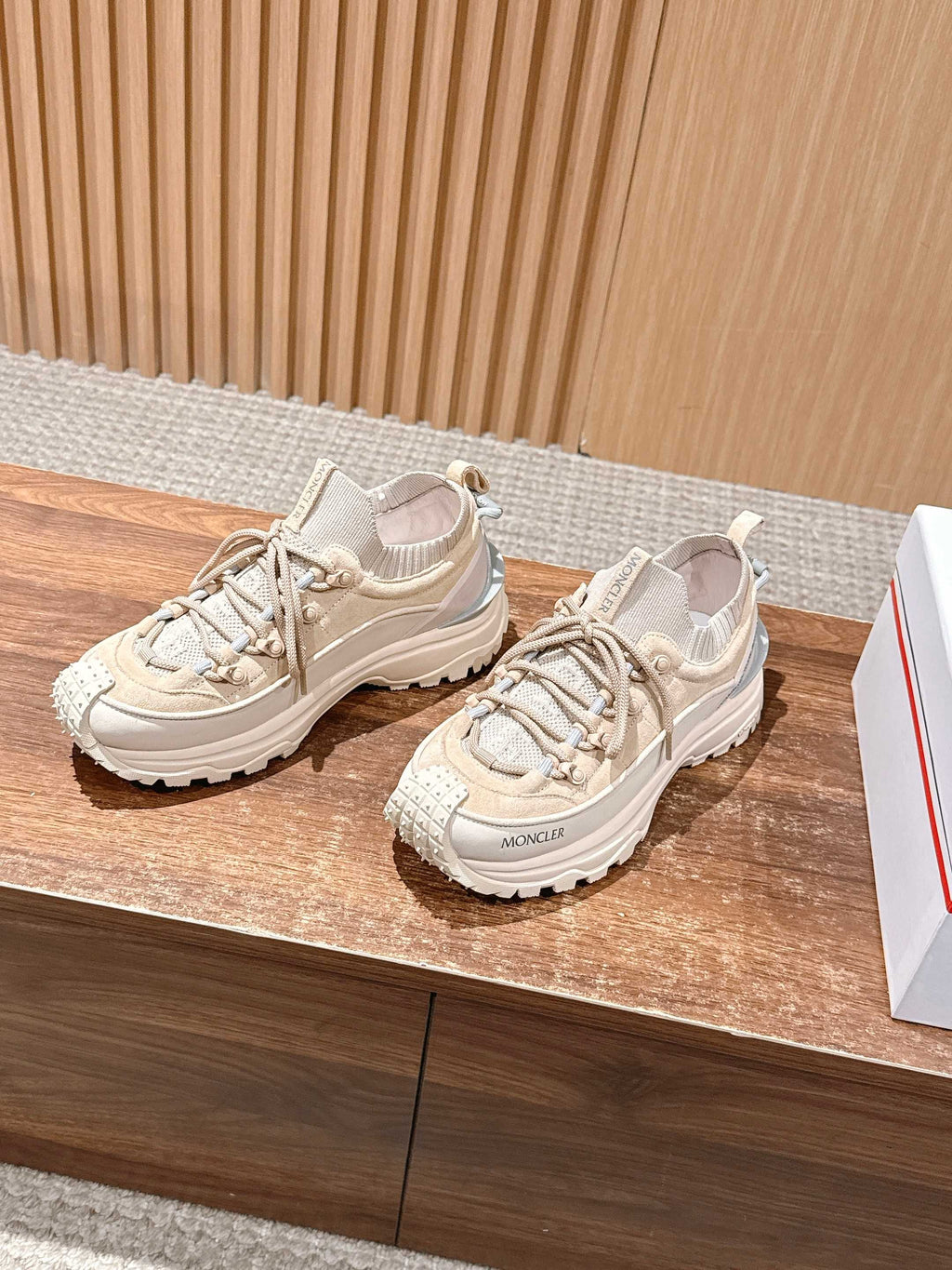 Moncler beige lace-up sneakers on display, side view with textured sole.